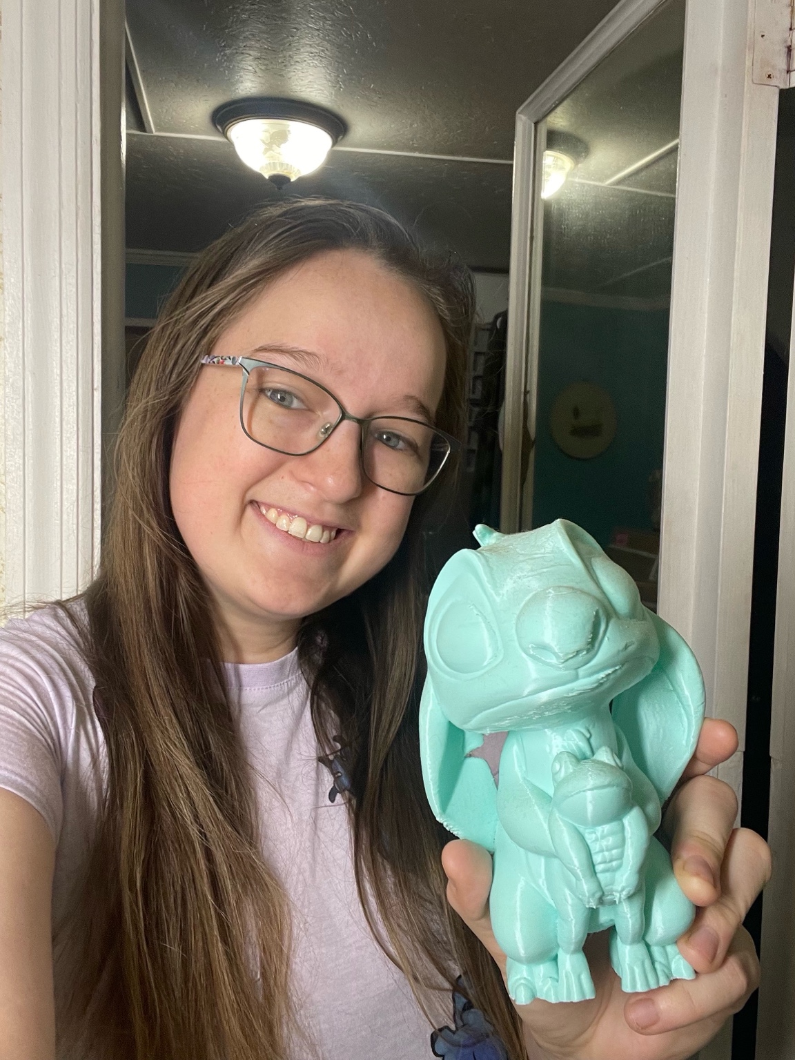 Customer Olivia holding a 3D printed Stitch dragon